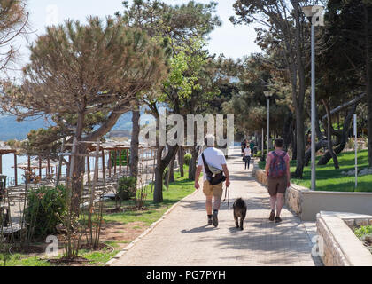 Elderly couple walking along the seafront,Rabac, Istria, Croatia. Stock Photo