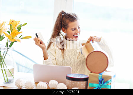 Picture of adult woman wearing warm sweater and shopping online in Christmas time Stock Photo