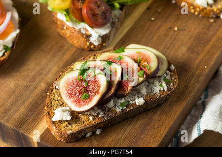 Homemade Breakfast Toasts with Cream Cheese Avocado Fig and Tomato Stock Photo