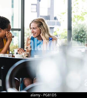 Best friends meeting in cafe, talking and sharing news Stock Photo