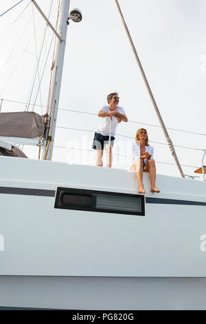 Mature couple making holidays, sailing on a catamaran Stock Photo