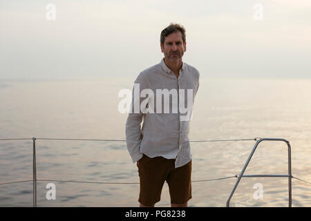 Marure man on catamaran Stock Photo