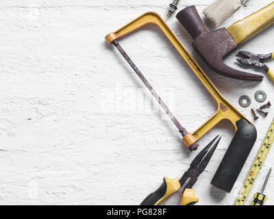 Old working tools. Vintage working tools on wooden background. Top view. Labor day concept with copy space. Stock Photo