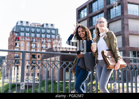 Friends walking on bridge, talking, having fun Stock Photo