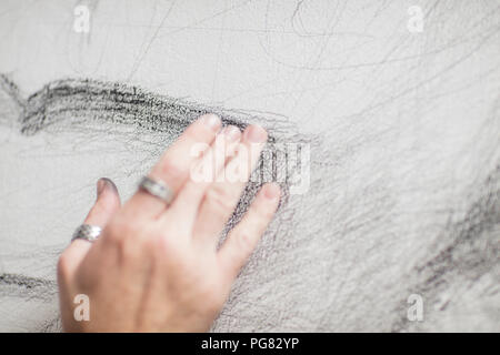 Artist's hand touching drawing Stock Photo