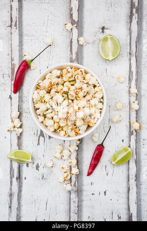 Bowl of popcorn flavoured with chili and lime Stock Photo