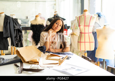 Young fashion designer working in her studio Stock Photo