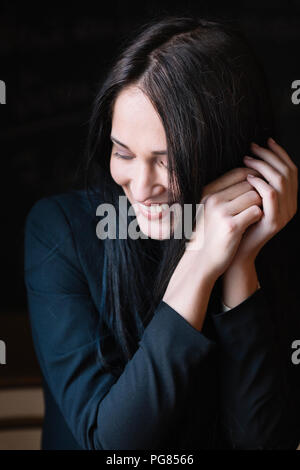 Portrait of smiling long-haired young woman Stock Photo