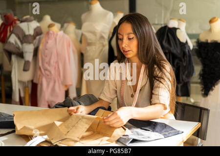 Young fashion designer working in her studio Stock Photo