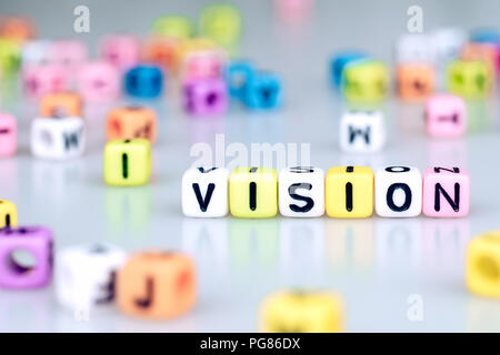 Vision word written on colorful cube with bokeh cube word block background Stock Photo