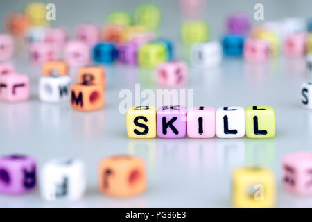 Skill word text written on colorful cube with bokeh cube word block background Stock Photo