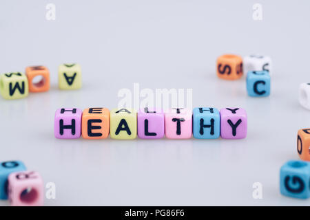 Healthy word text written on colorful cube with bokeh cube word block background Stock Photo