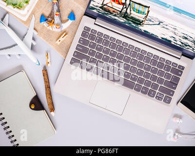 Top view of beach travel concept with laptop computer, notebook, smartphone, with copy space. Beach tropical travelling planning concept. Stock Photo