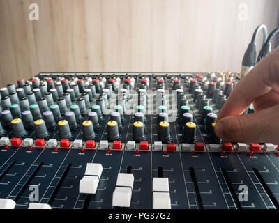 Producing music in studio on audio console mixer Stock Photo