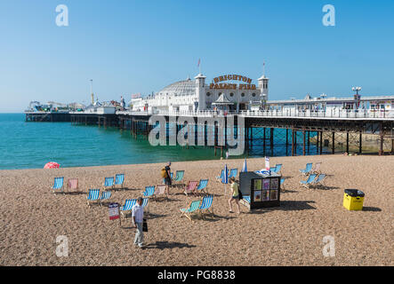 Brighton Palace Pier, a British seaside pier and shingle beach in Summer in Brighton, East Sussex, England, UK. Brighton pier blue sky. Stock Photo