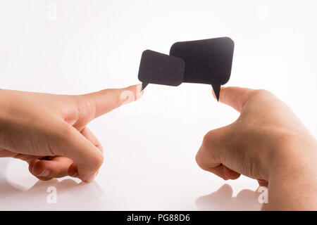 Hand holding dialogue boxes on a white background Stock Photo