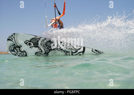 Mallorca, Spain. 24th Aug, 2018. Mark (46) from Barcelona, owner and instructor of a water sports school in Playa de Muro Beach, shows his skills. A wider range of water sports and nautical activities has been available for years in the region around Playa de Muro to meet the growing tourist demand. Credit: Clara Margais/dpa/Alamy Live News Stock Photo