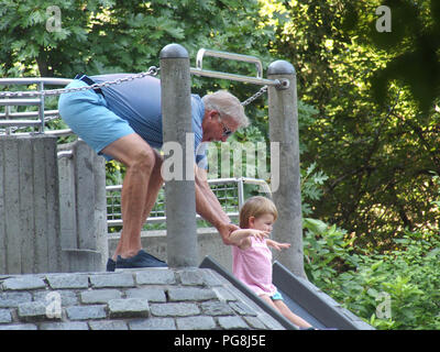 New York, USA. August 24, 2018 - New York, New York, U.S. - Hall of Fame Quarterback John Elway with family in New York's Central Park. John plays with child in playground. Credit: Bruce Cotler/Globe Photos/ZUMA Wire/Alamy Live News Stock Photo