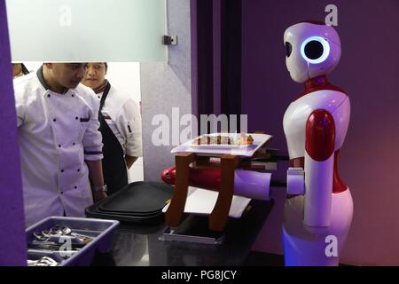 Kathmandu, Nepal. 24th Aug, 2018. Robot Ginger receives food from kitchen at Naulo Restaurant, an automated restaurant in Kathmandu, Nepal, Aug. 24, 2018. Credit: Sunil Sharma/Xinhua/Alamy Live News Stock Photo