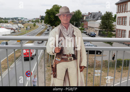 Worms, Germany. 24th August 2018. A cardboard cut-out of Terence Hill stands on the bridge. Italian actor Terence Hill visited the German city of Worms, to present his new movie (My Name is somebody). Terence Hill added the stop in Worms to his movie promotion tour in Germany, to visit a pedestrian bridge, that is unofficially named Terence-Hill-Bridge (officially Karl-Kubel-Bridge). Stock Photo
