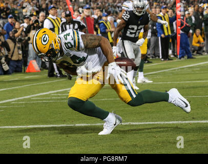 Green Bay Packers' Lance Kendricks catches a pass between Tampa Bay  Buccaneers' Kwon Alexander and Ryan Smith (29) during the first half of an NFL  football game Sunday, Dec. 3, 2017, in