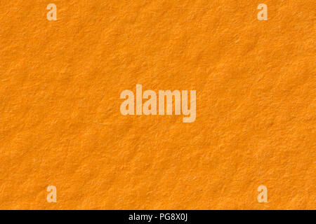 Orange paper texture background on macro. Plain backdrop. Stock Photo