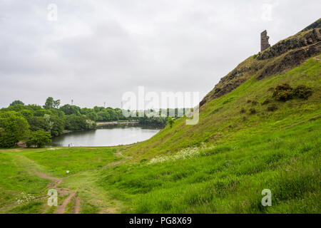 The ruins of St. Anthony's chapel, loom above St. Margaret's Loch, Holyrood Park, Edinburgh, Scotland, UK. Stock Photo