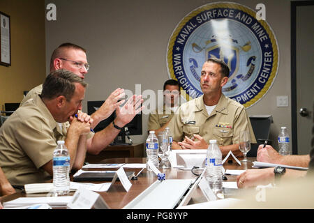 SAN DIEGO (Aug. 22, 2018) Chief of Naval Operations Adm. John Richardson, right, listens in during a brief by Rear Adm. Dave Welch, commander, Naval Surface and Mine Warfighting Development Center (SMWDC) during a visit to the command. SMWDC is one of the Navy's five Warfighting Development Centers and its mission is to increase the lethality and tactical proficiency of the Surface Force across all domains. (U.S. Navy photo by Lt. Matthew A. Stroup/Released) Stock Photo