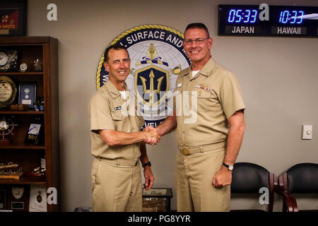 SAN DIEGO (Aug. 22, 2018) Chief of Naval Operations Adm. John Richardson, left, poses for a photograph with Rear Adm. Dave Welch, commander, Naval Surface and Mine Warfighting Development Center (SMWDC) during a visit to the command. SMWDC is one of the Navy's five Warfighting Development Centers and its mission is to increase the lethality and tactical proficiency of the Surface Force across all domains. (U.S. Navy photo by Lt. Matthew A. Stroup/Released) Stock Photo