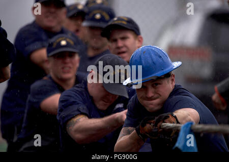 Crewmembers of the Coast Guard Cutter Anthony Petit, homeported in Ketchikan, Alaska, use every ounce of strength in their tug-o-war loss to the crew of the Coast Guard Cutter Sycamore during the Buoy Tender Roundup Olympics at Coast Guard Station Juneau, Alaska, Aug. 22, 2018. The Olympics is a competition that not only builds morale amongst cutter members but also provides a fun alternative to every day training in events such as the chain pull, survival swim and the heat-and-beat. U.S. Coast Guard photo by Petty Officer 1st Class Jon-Paul Rios. Stock Photo