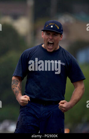 A member of the Coast Guard Cutter Sycamore, homeported in Cordova, Alaska, yells in excitement after taking first place in the tug-o-war competion during the Buoy Tender Roundup Olympics at Coast Guard Station Juneau, Alaska, Aug. 22, 2018. The Olympics is a competition that not only builds morale amongst cutter members but also provides a fun alternative to every day training in events such as the chain pull, survival swim and the heat-and-beat. U.S. Coast Guard photo by Petty Officer 1st Class Jon-Paul Rios. Stock Photo