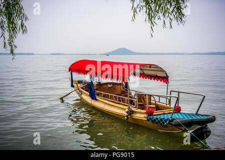 Traditional chinese boat close-up view in Wuhan city Donghu east lake and Moshan hill in background China Stock Photo