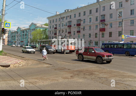 Komsomolsk-on-Amur, Russia - May 25, 2018: Old red tram on the rail station 'Hotel Voskhod' in the middle line of the street 'Prospekt Lenina' Stock Photo