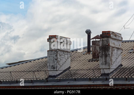 Two old chimneys the roof of an apartment house, Komsomolsk-on-Amure, Russia Stock Photo