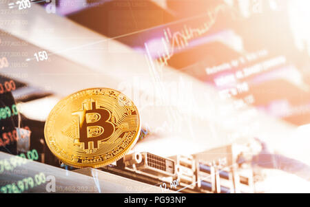 Bitcoin Cryptocurrency background concept - Golden bitcoin with a computer graphic card or GPU rig cryptocurrency mining unit with bitcoin trading gra Stock Photo