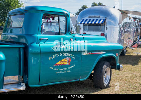 Vintage Chevrolet 3100 pickup truck with an airstream caravan at a vintage retro festival. UK Stock Photo