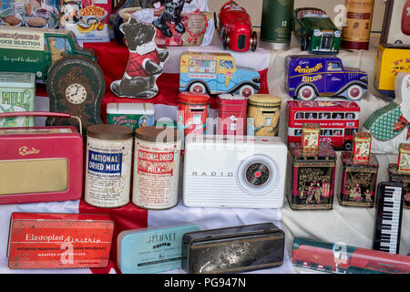 Old and Reproduction tins for sale on a stall at a vintage retro festival. UK Stock Photo