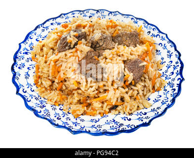 above view of cooked pilaf (central asian dish from rice with meat and vegetable) on local ceramic plate isolated on white background Stock Photo