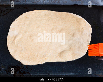 cooking of pie - sheet of raw dough on baking tray Stock Photo