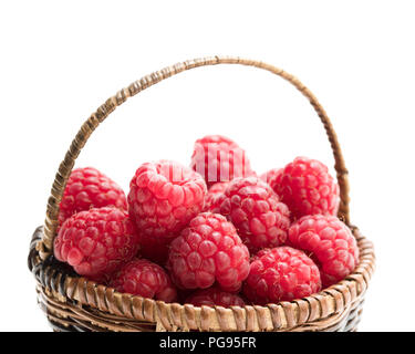 Fresh  raspberries in a small wicker basket Stock Photo