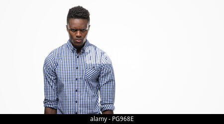 Young african american man wearing blue shirt skeptic and nervous, frowning upset because of problem. Negative person.