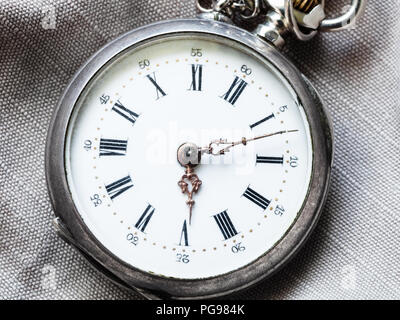 retro pocket watch on gray textile background close up Stock Photo