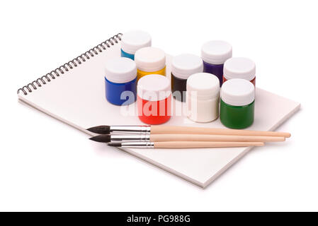 Paints, brushes and sketchbook isolated on white Stock Photo