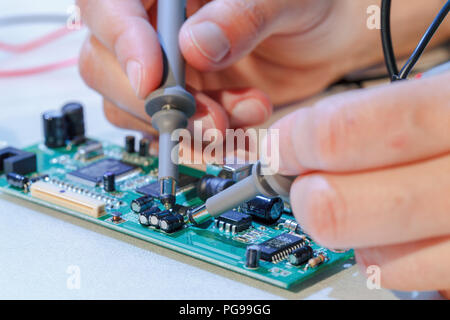 Repairing printed circuit board. Stock Photo