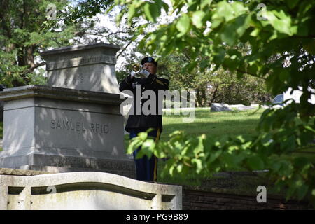 Staff Sgt. David Lambermont, 88th Readiness Division’s 338th Army Band bugler, performs Taps during at a wreath laying ceremony for President Benjamin Harrison at Crown Hill Cemetery, in Indianapolis, on Aug. 18, to commemorate the Hoosier President’s 185th birthday. (US Army photo by Catherine Carroll) Stock Photo