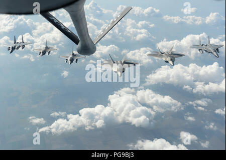 U.S. Air Force F-15C Eagles, F-22 Raptors and Romanian F-16 Fighting Falcons fly in formation above Bucharest, Romania, Aug. 20, 2018. During their deployment to Germany, the F-22s forward deployed to operating locations to assert the U.S. ability to quickly respond and assure allies and partners of U.S. presence in Europe is forward and ready. (U.S. Air Force photo by Senior Airman Dawn M. Weber) Stock Photo