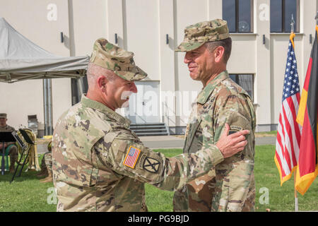 Lt. Gen. Christopher G. Cavoli, Commander of United States Army Europe (USAREUR) places the USAREUR Patch on the Uniform of Maj. Gen. Andrew M. Rohling, incoming Deputy Commander of USAREUR during the Welcome Patch Ceremony held on Clay Kaserne in Wiesbaden, Germany, Aug. 20, 2018. Stock Photo