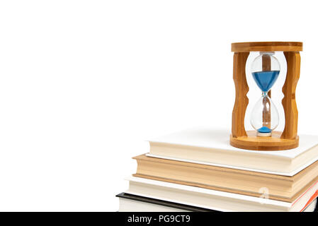 Hourglass and books isolated on white background. Stock Photo
