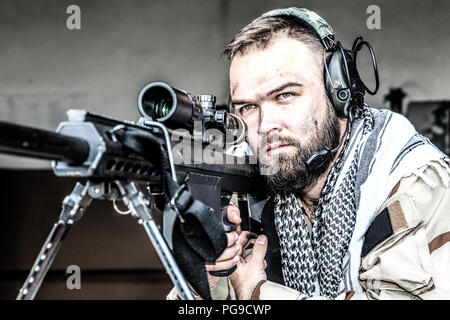 Army sniper in combat readiness on firing position Stock Photo