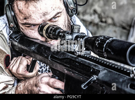 Army sniper in combat readiness on firing position Stock Photo